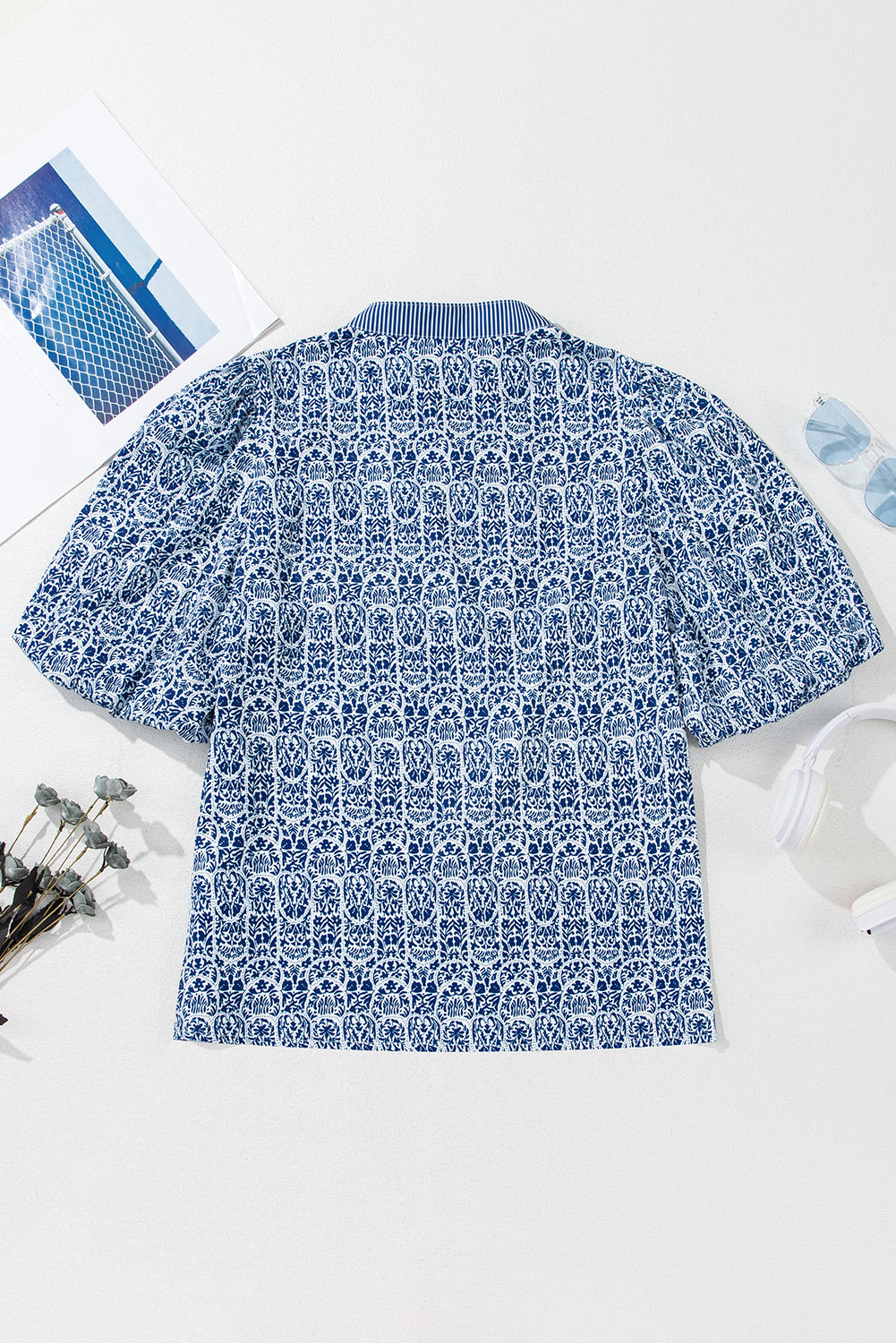 Top de manga abullonada con estampado floral azul y rayas en contraste.