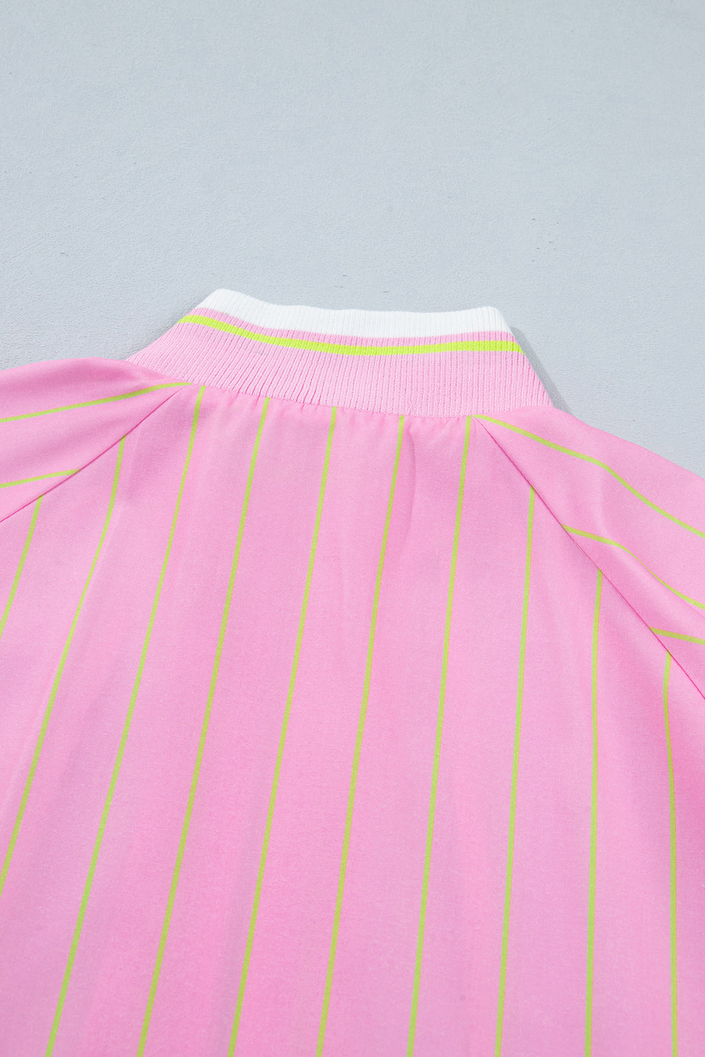 Blusa informal de corte recto con cuello en V, mangas cortas, cremallera y puños acanalados, de rayas rosas.