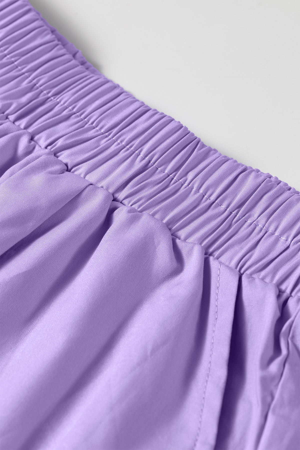 Conjunto de 2 piezas: top de manga larga con medio botón y rayas moradas, y shorts combinables.